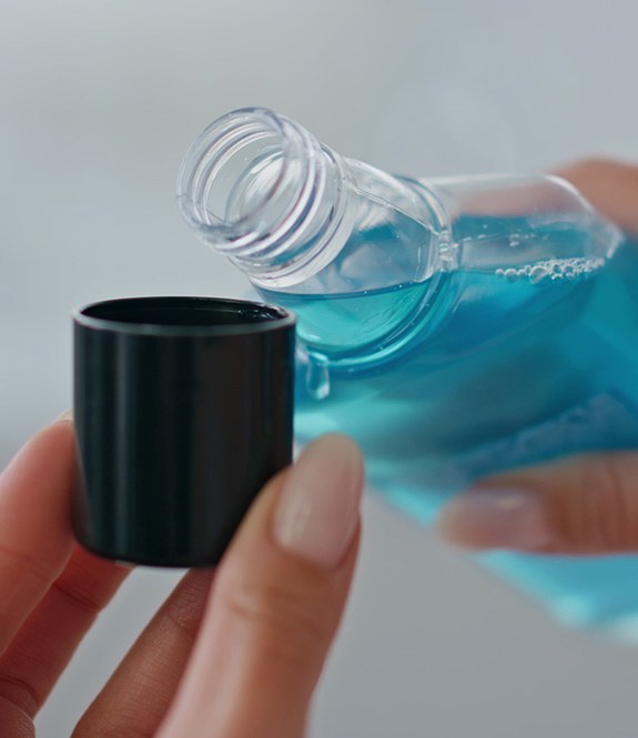 Woman holding mouthwash