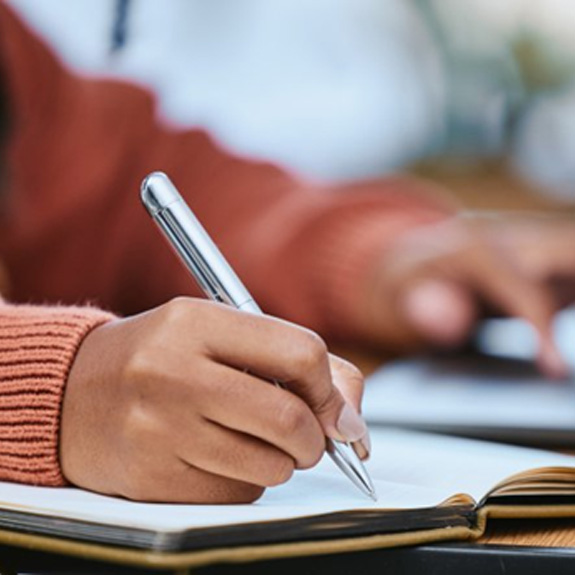 Teacher writing in a notebook
