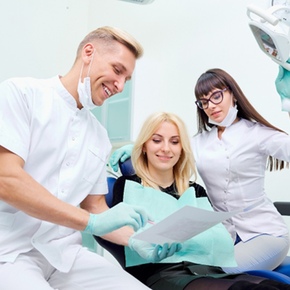 Dentist talking to female patient