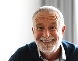 Close-up of a bearded senior man smiling