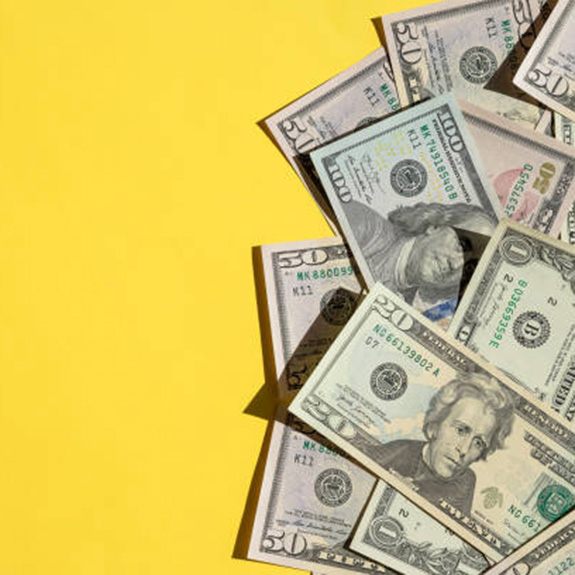 Large amount of cash spread out on yellow background