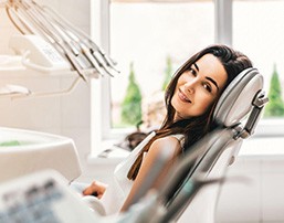 Smiling young woman in dentist’s chair