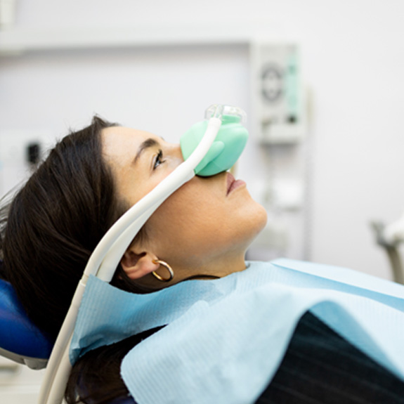 Female patient receiving sedation dentistry during appointment